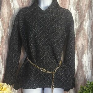 Elegant black sweater with intricate black and silver patterns.